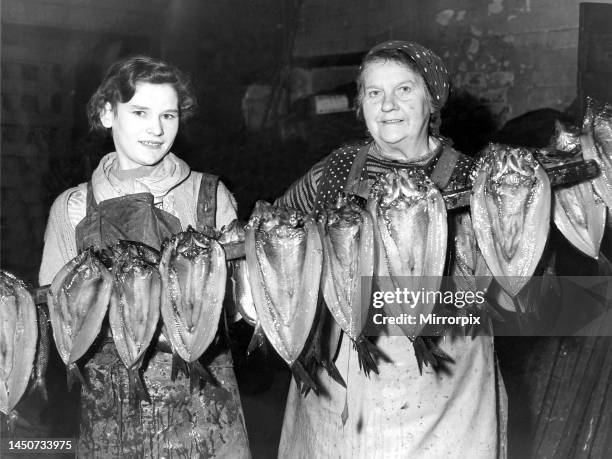 Nellie Dempsey of North Shields and Annie Raffan of Peterhead with some herrings after they have been pickled and are ready for the smoke house in...