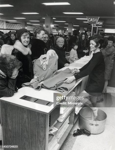 Year-old Miss Clementine Wilson, who is a sales girl in C&A, pictured as she cools her feet down after Christmas sale rush. Miss Wilson had to borrow...