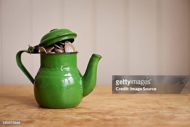 money in a teapot - loose change private view stock pictures, royalty-free photos & images