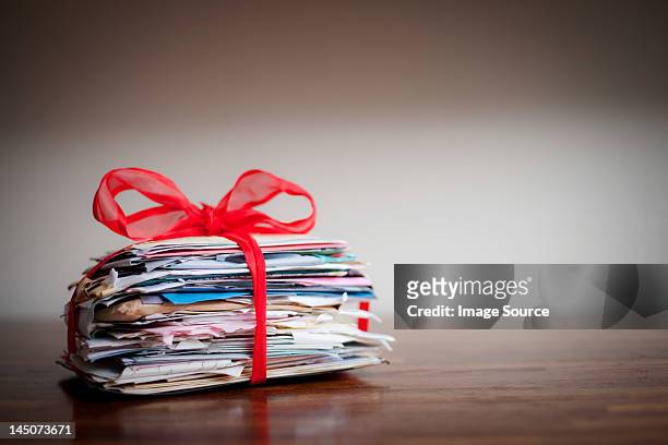 stack of letters tied together with ribbon - love letter stock pictures, royalty-free photos & images