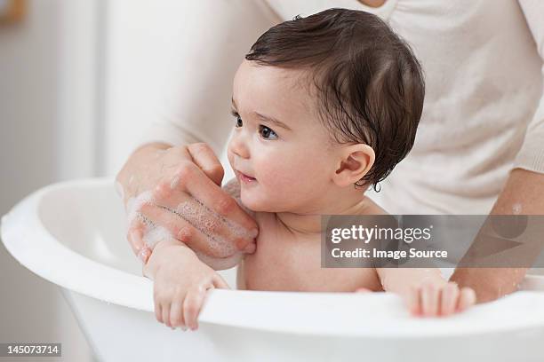 baby boy having a bath - baby bath stock pictures, royalty-free photos & images