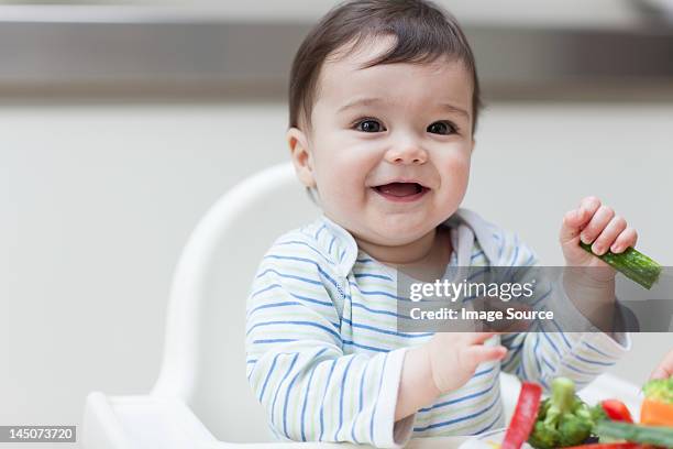 baby boy eating healthy vegetables - baby eating vegetables stock pictures, royalty-free photos & images