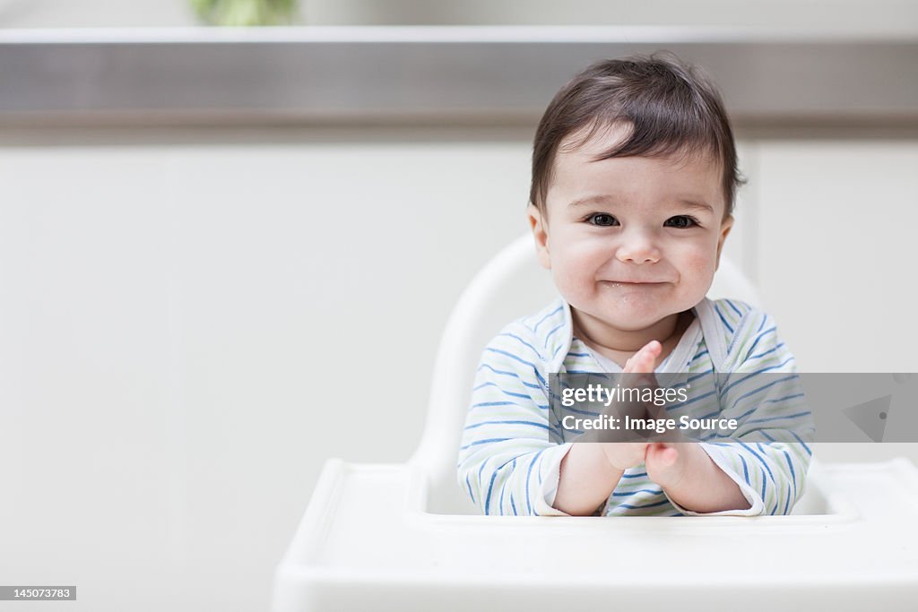 Happy baby in high chair