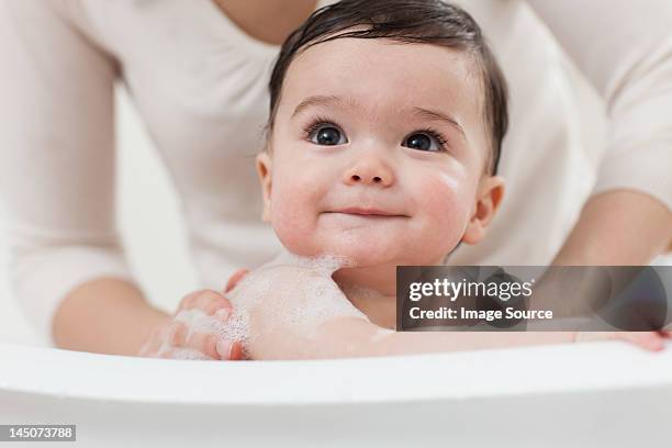 baby boy having a bath - mother and baby taking a bath stock-fotos und bilder