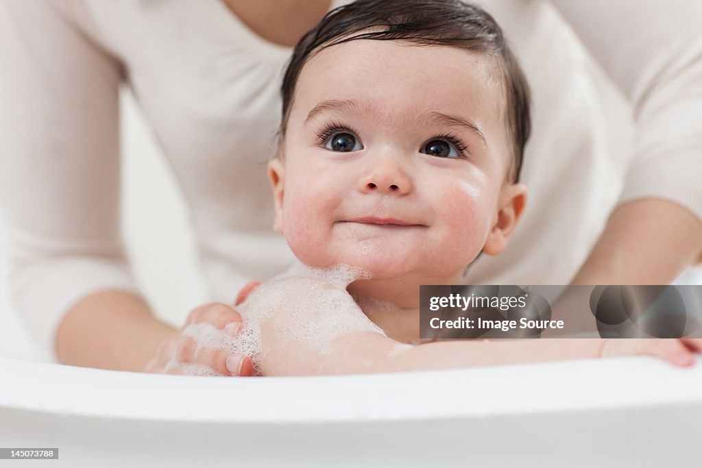 Baby boy having a bath