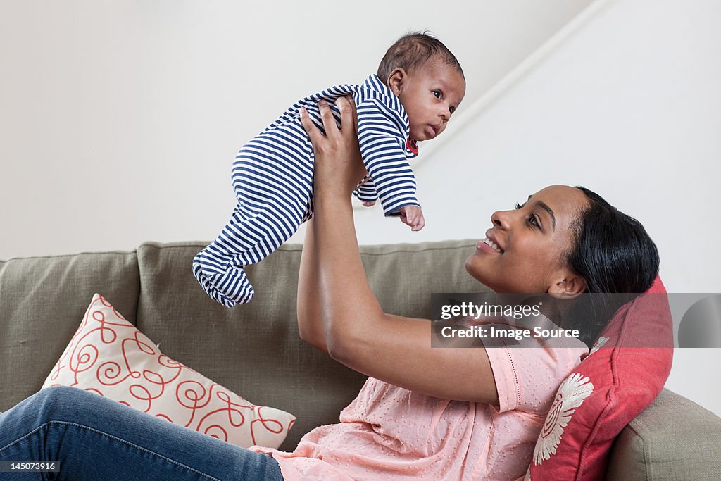 Mother lifting baby boy