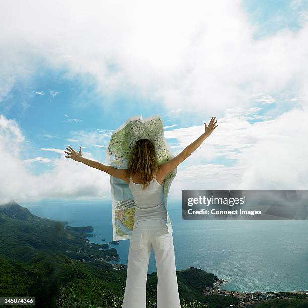 young woman with map blowing over her face - funny tourist stock pictures, royalty-free photos & images