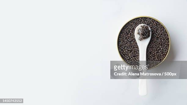directly above shot of black peppercorns in spoon against white background,finland - kaviaar stockfoto's en -beelden
