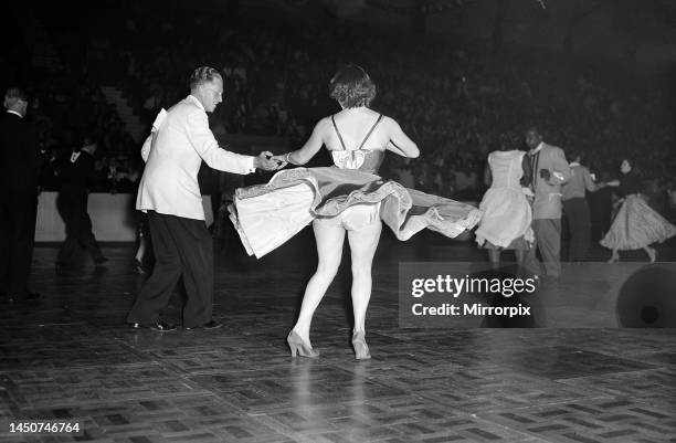 Couples perform on the dance floor during the Jive Championship held at Haringey dance hall London, June 1956.