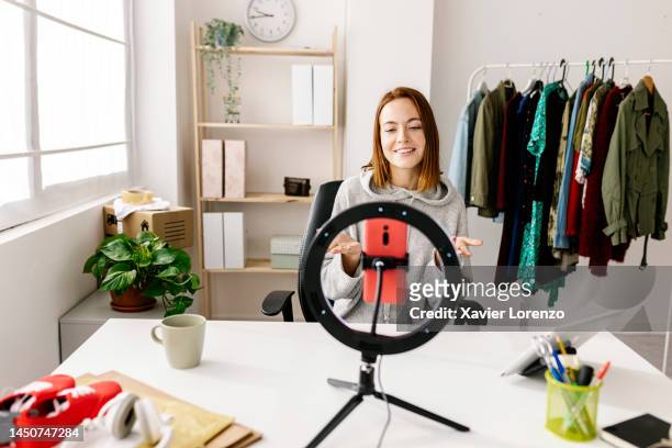 female owner making video reels for social media network talking about new arrival clothes using mobile phone app at showroom store. small business and entrepreneur people concept - new broadcasting house stock pictures, royalty-free photos & images