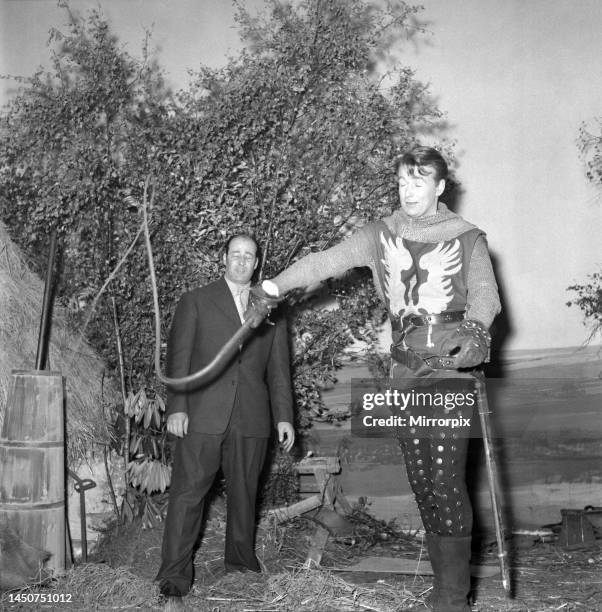 On set with the cast of the television series The Adventures of Sir Lancelot . William Russell who stars as Sir Lancelot is seen here being shown how...