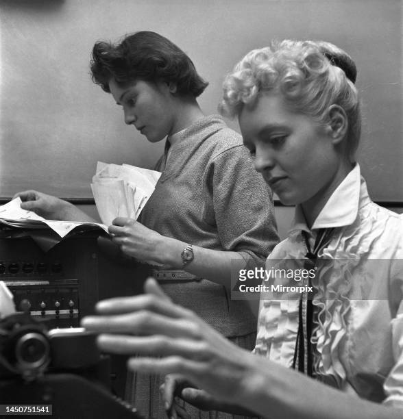 Secretary taking notes and answering the phone in a Birmingham office. Circa 1955.