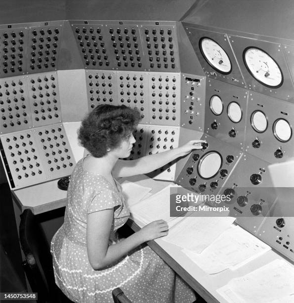 Operators working at the control panels of the new Bristol Aircraft Ltd Duce digital computer and Flutter Simulator. Besides the remarkable speed the...