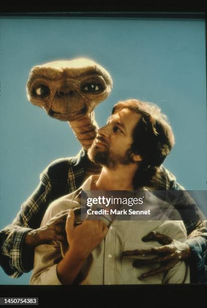 Steven Spielberg poses with E.T. At Carlo Rimbaldi studio in April, 1982 in Los Angeles, California.