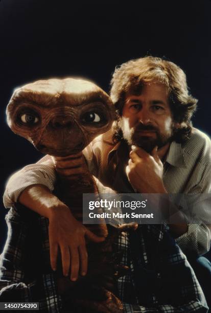 Steven Spielberg poses with E.T. At Carlo Rimbaldi studio in April, 1982 in Los Angeles, California.