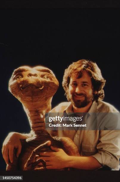 Steven Spielberg poses with E.T. At Carlo Rimbaldi studio in April, 1982 in Los Angeles, California.
