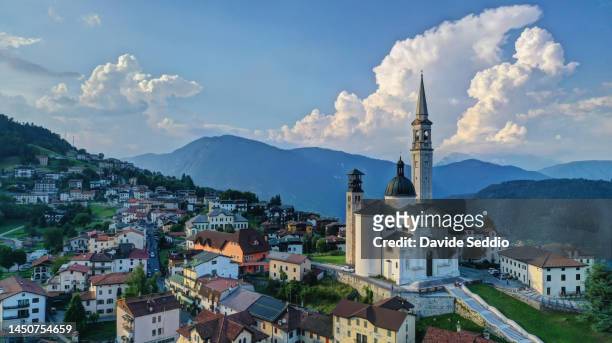 aerial view of the church and village of enego on the asiago plateau - asiago italy stock pictures, royalty-free photos & images