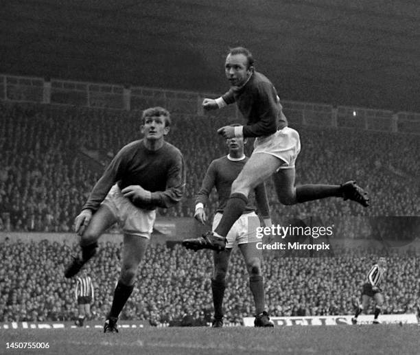 Manchester United's goalkeeper Alex Stepney looks on anxiously as defender Nobby Stiles gets his head to the ball for a corner during their league...