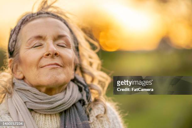 senior woman outdoors - beautiful woman candid face 個照片及圖片檔