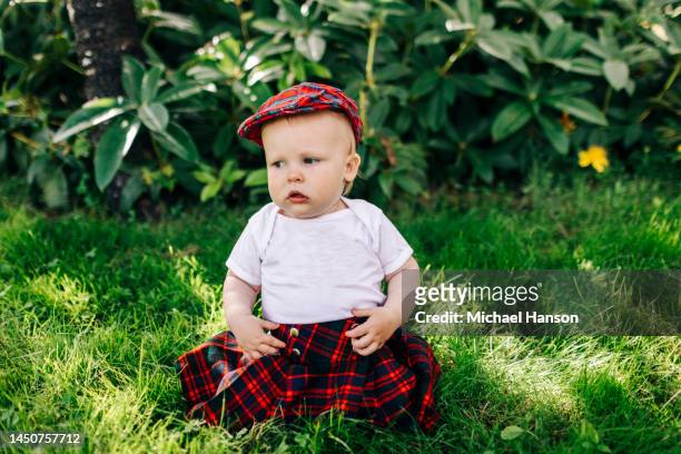 an infant turns one and enjoys a healthy cake at his birthday party. - scottish culture fotografías e imágenes de stock