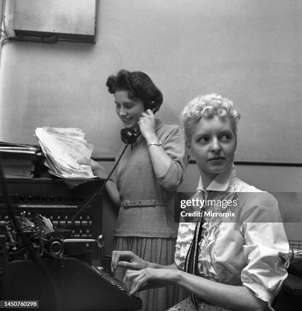 Secretary taking notes and answering the phone in a Birmingham office. Circa 1955.