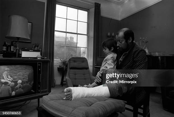 Clement Freud at home with broken leg, pictured with his daughter Emma. March 1969.