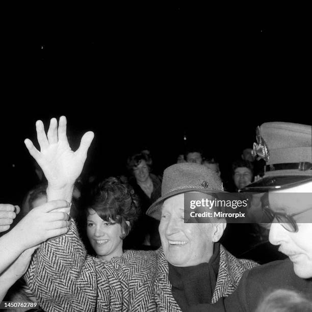 Maurice Chevalier with people from the audience at the Palladium. Feb 1968.