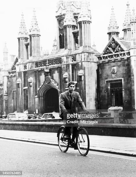 Prince Charles cycles past King's College Cambridge.