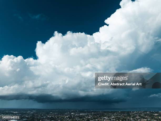 aerial shot showing a storm cloud over nassau, new providence, bahamas - bahamas city stock pictures, royalty-free photos & images