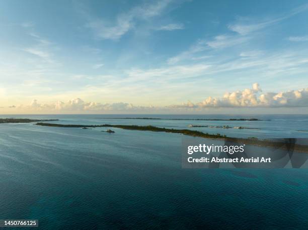 athol island at sunset photographed from an aerial point of view, bahamas - athol bay stock pictures, royalty-free photos & images