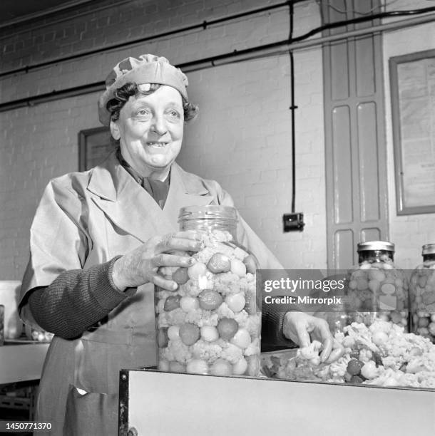 Pickle packers placing onions in jars, 1954.