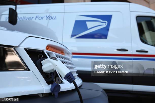 The United States Postal Service unveils two of its battery-powered vehicles at an event announcing its plan on implementing electric vehicles, at...