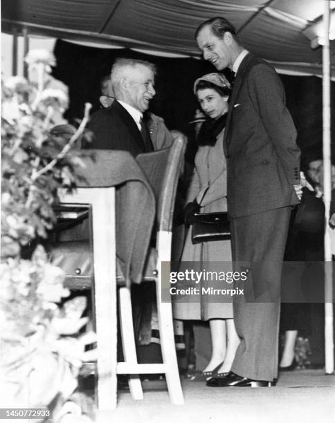 Queen Elizabeth II with Prince Philip visit South Shields, sharing a joke with Alfred Evans, a South Shields foundryman. October 1954.