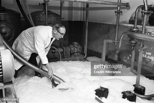 Workman at Ansells Brewery in Birmingham, pouring half a million pints of Pale Ale down the drain due to an industrial dispute. 16th February 1968.