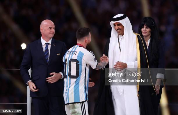 Lionel Messi of Argentina is congratulated by Sheikh Tamim bin Hamad Al Thani, Emir of Qatar, during the awards ceremony after the FIFA World Cup...