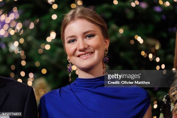 Princess Elisabeth of Belgium poses in front of the Christmas tree after the annual Christmas concert at the Royal Palace on December 20, 2022 in...