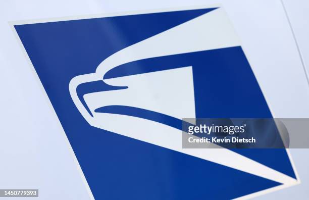 The United States Postal Service logo is seen on a new electric postal vehicle during an event announcing the Postal Service's plan on implementing...