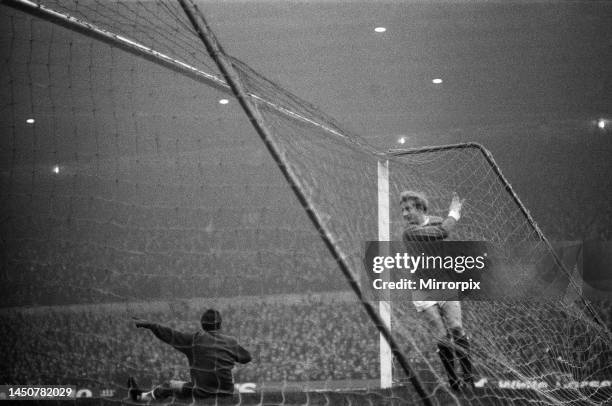 Manchester United forward Denis Law in the back of the Liverpool goal after scoring the game's only goal past dejected goalkeeper Tommy Lawrence...