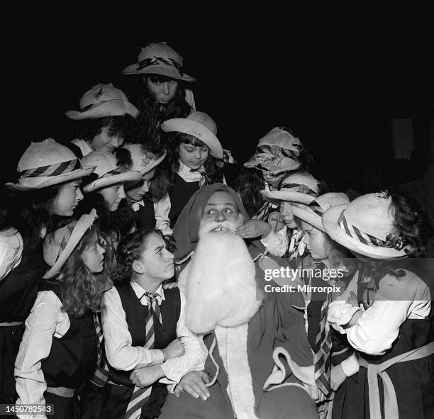 Terry Thomas in 1957 as Father Christmas with girls from St Trinian's.
