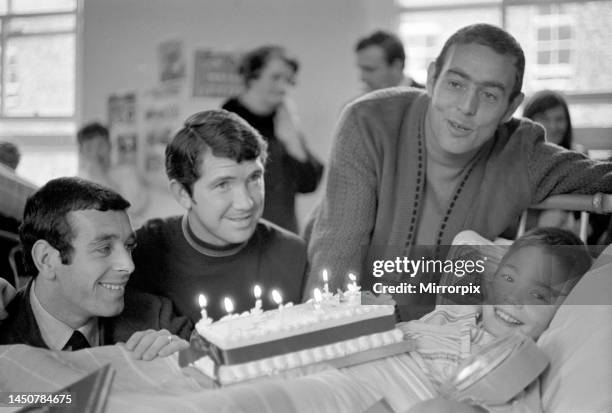 Liverpool players Ian Callaghan, Chris Lawler and Ian St. John visit a boy recovering from an operation at Alder Hey children's hospital. November...