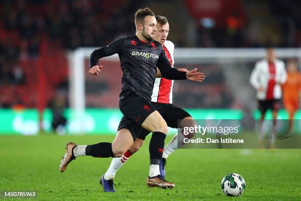 Charles Vernam of Lincoln City FC battles for the ball with James Ward-Prowse of Southampton FC during the Carabao Cup Fourth Round match between...