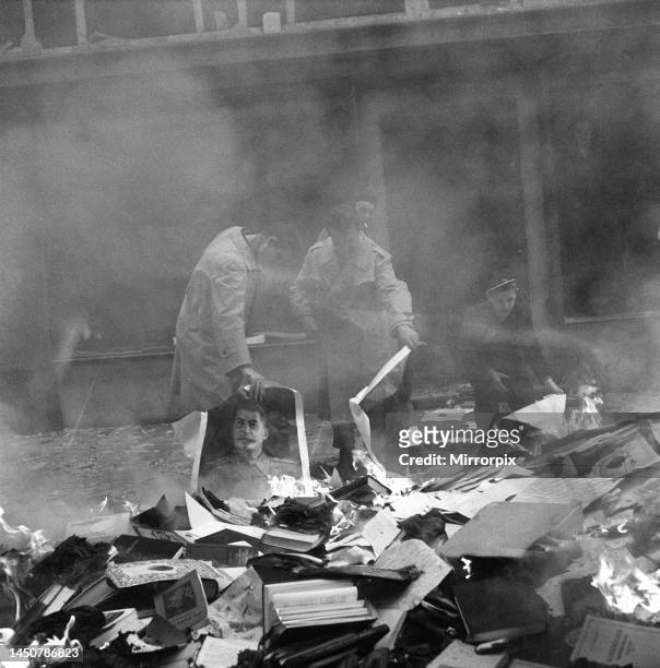 Hungarian people burning pictures of Stalin and books from a ransacked Russian bookshop. Budapest, Hungary. October 1956.