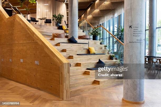 creative workspace with workstations on wooden steps - architecture restaurant interior bildbanksfoton och bilder