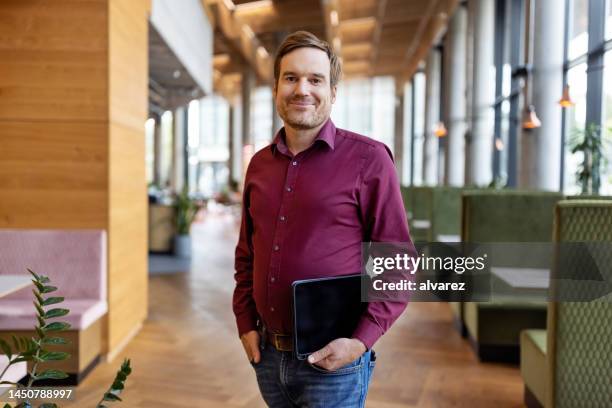 portrait of happy middle-aged businessman standing in startup office - food and drink establishment stock pictures, royalty-free photos & images