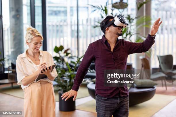 business people testing out virtual reality software within the metaverse - 360 tablet stock pictures, royalty-free photos & images