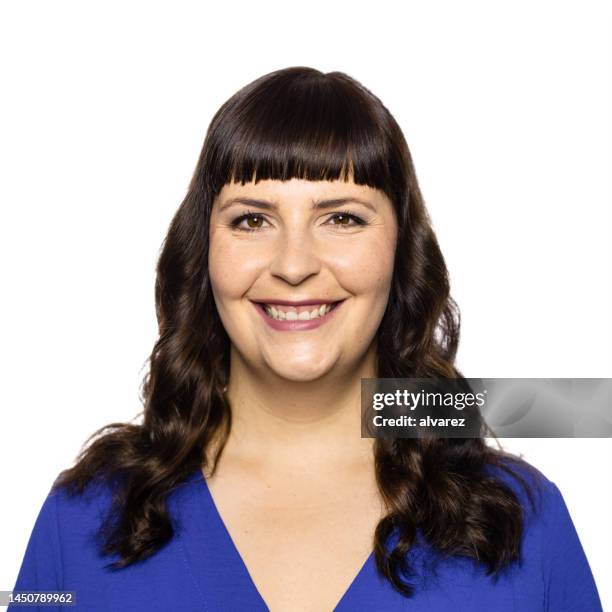 portrait of smiling mid adult woman against white background - chubby face stockfoto's en -beelden