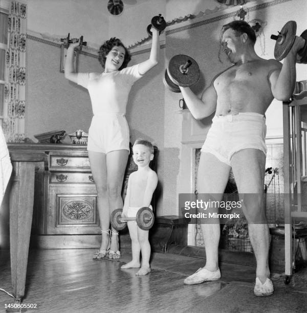 The Pickle family is a strong family as these picture show mum and dad weight training with son Eric. November 1953.
