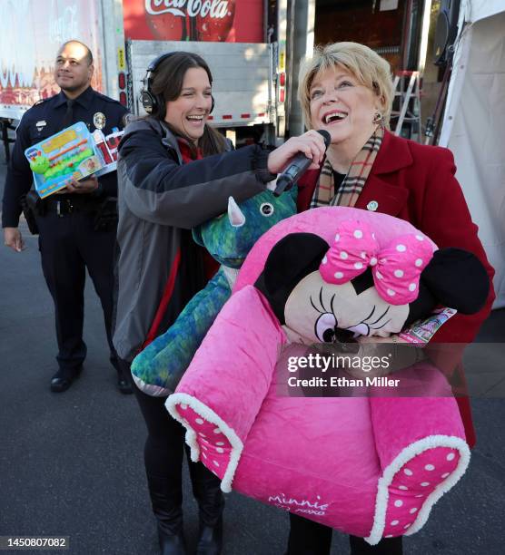 Las Vegas Mayor Carolyn Goodman holds toys she brought for donations as she talks with Kayla Fishman, co-host of 98.5 KLUC's "The Chet Buchanan...