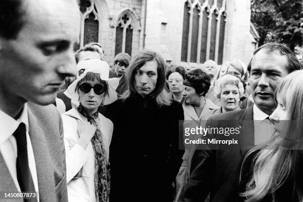 Brian Jones' funeral. Charlie Watts and his wife, Shirley, with other mourners. 10th July 1969.