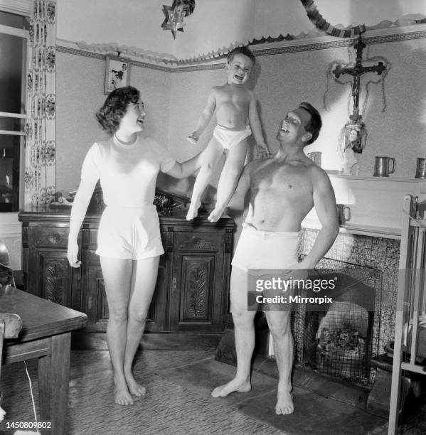 The Pickle family is a strong family as these picture show mum and dad weight training with son Eric. November 1953.